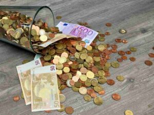 Euro e banconote cadute da un bicchiere