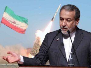 Il Ministro degli Esteri iraniano, sullo sfondo un missile parte dallo stretto di Hormuz