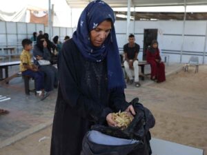 Una donna palestinese a Gaza cerca di procurarsi cibo